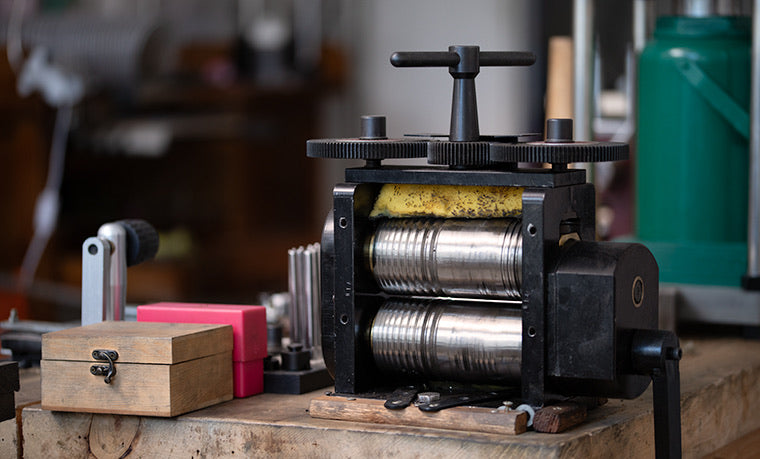 Rolling mill in a jewelry studio for thinning and shaping sterling silver and gold sheet.