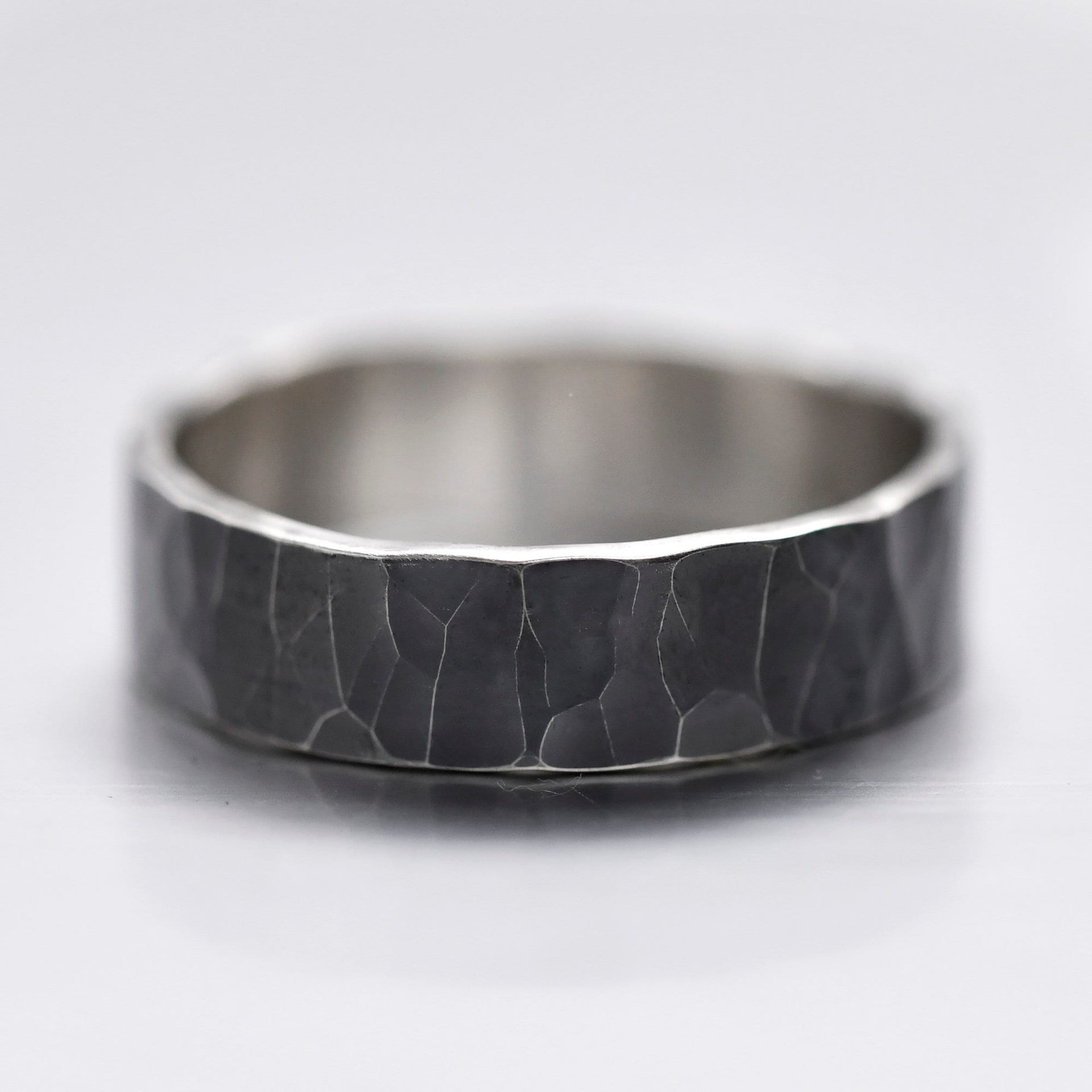Deep hammered oxidized sterling silver ring with a rugged dark texture, handmade by YophieMade.