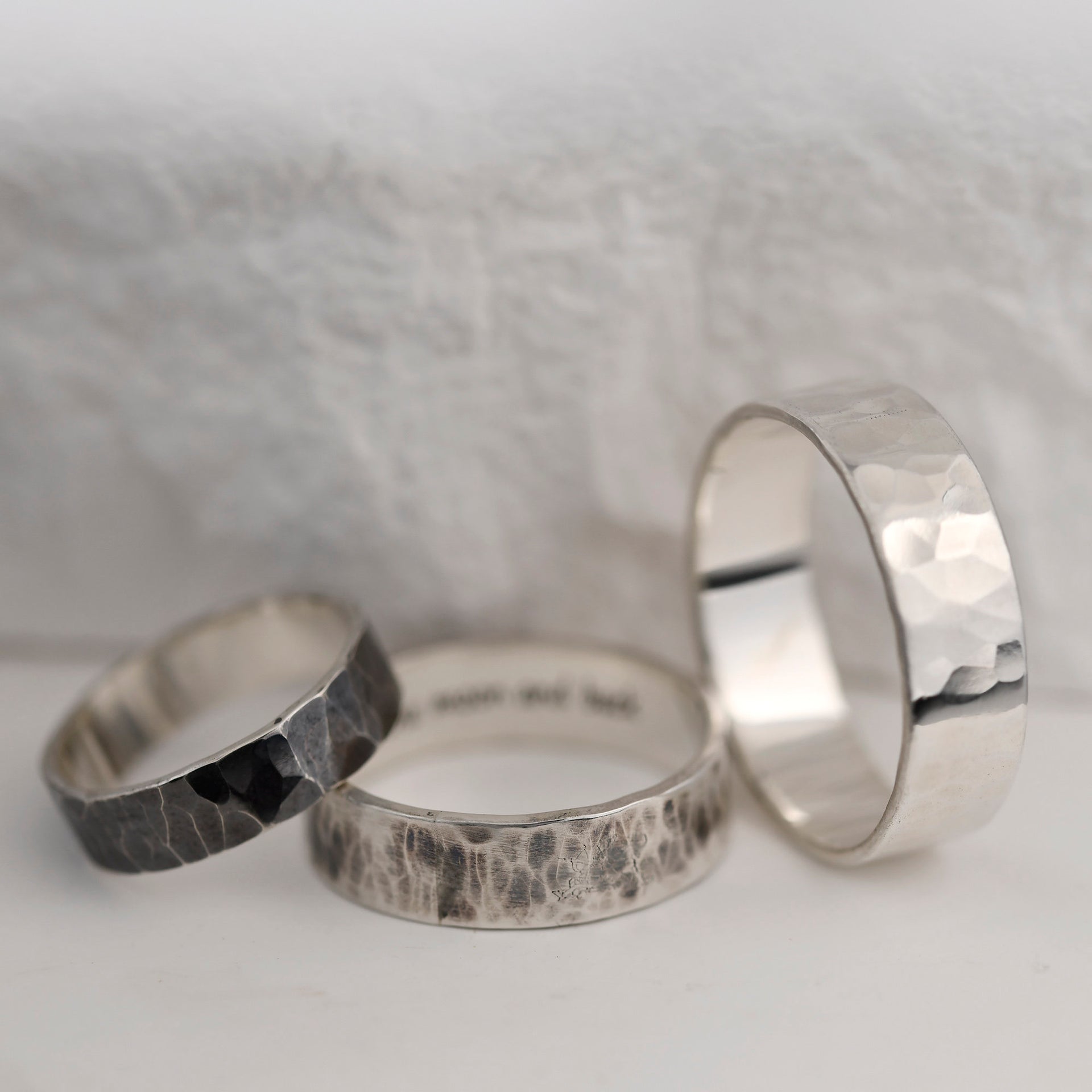 Wide hammered sterling silver ring with gunmetal patina and handcrafted rustic character.