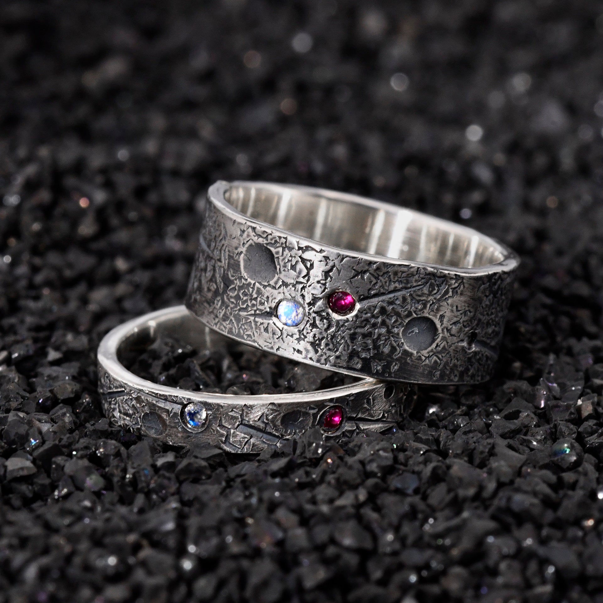 Close up of custom birthstones on handmade celestial ring pair