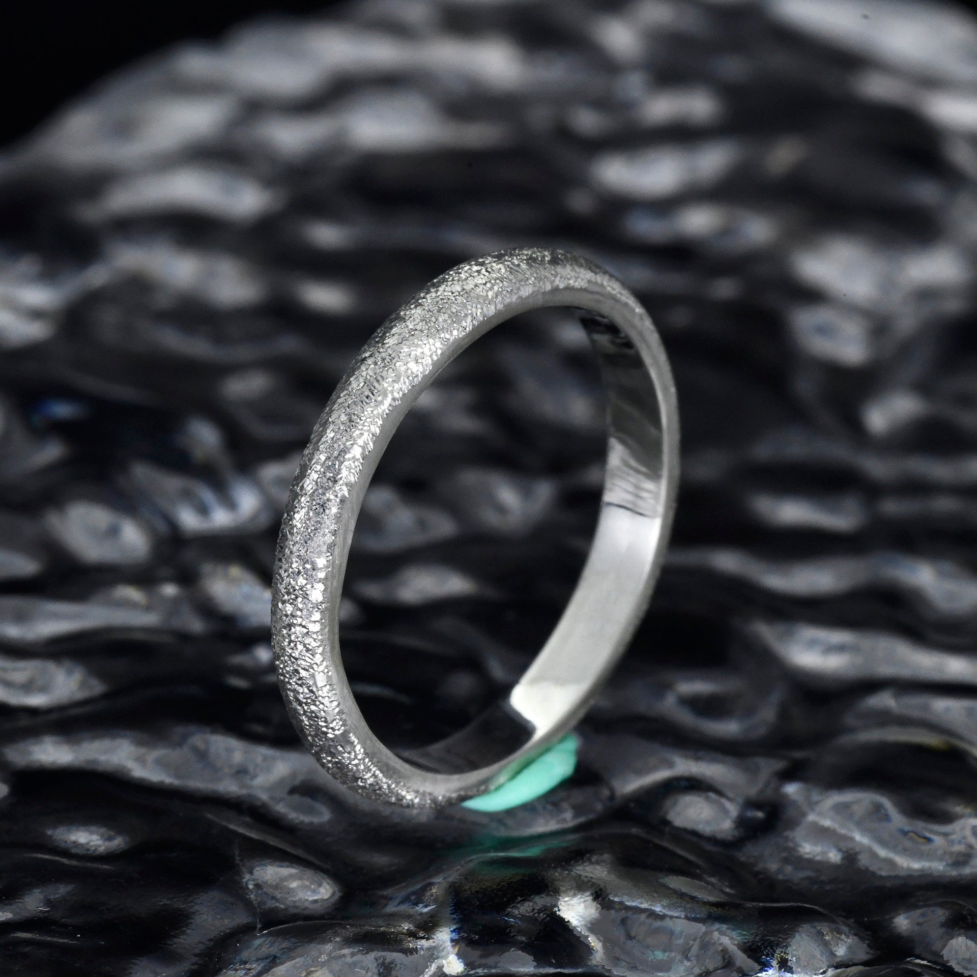 Close up of fine sterling silver texture with light catching finish