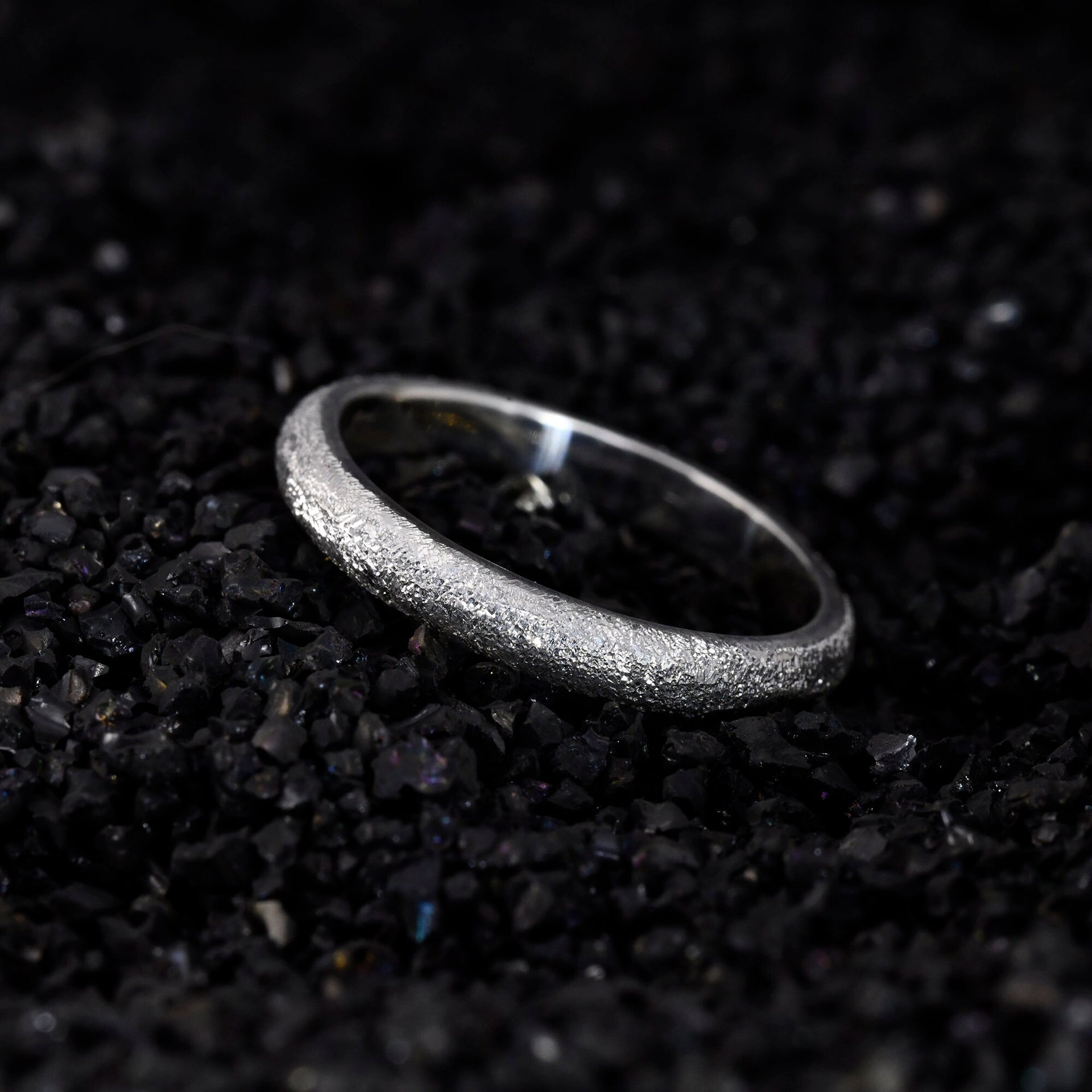 Thin silver stackable ring shown on hand for delicate fit