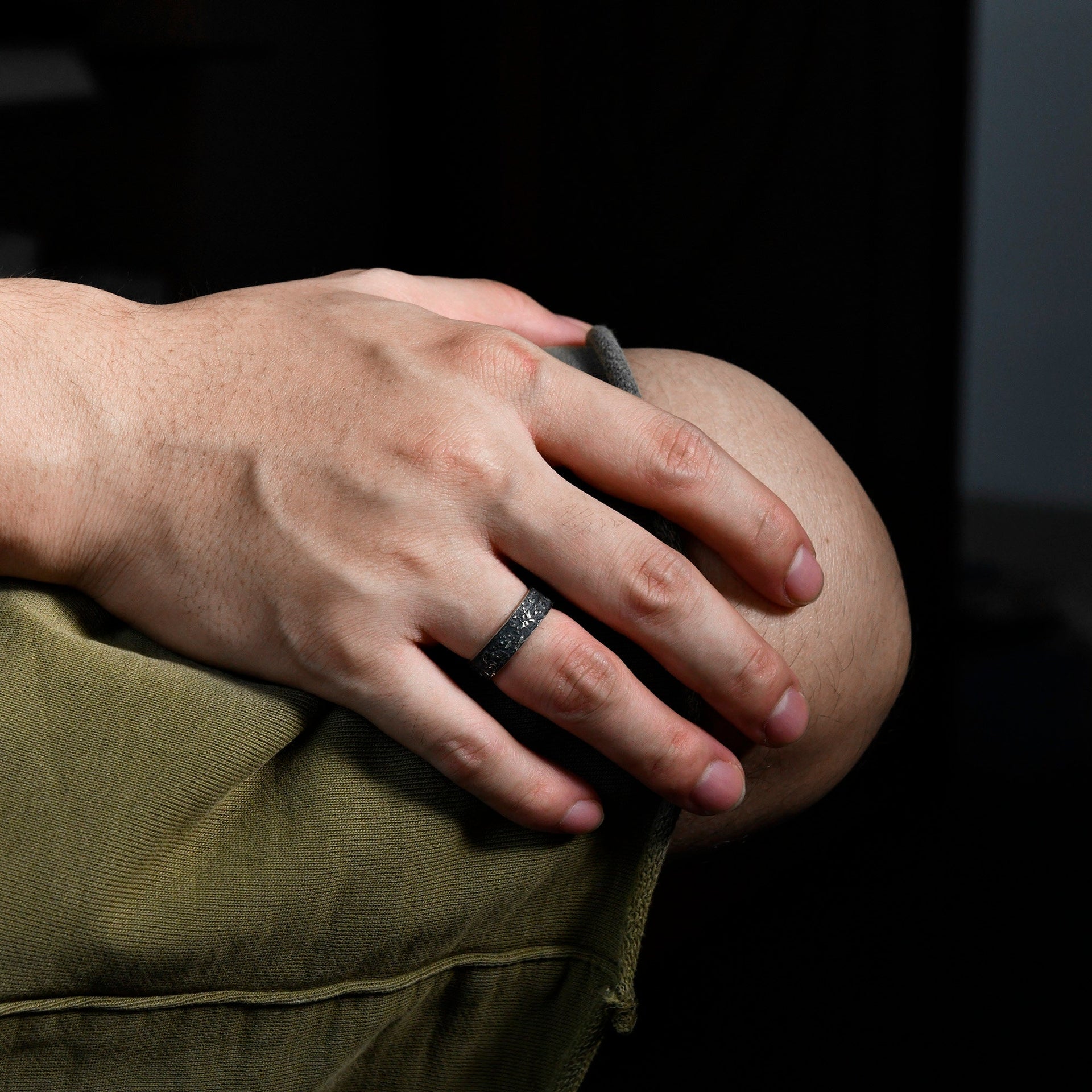 Side view of the 6mm silver galaxy ring with rugged oxidized texture and polished edges.