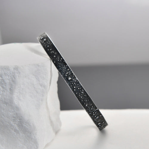 Slim adjustable gunmetal grey cuff bracelet with engraved stars