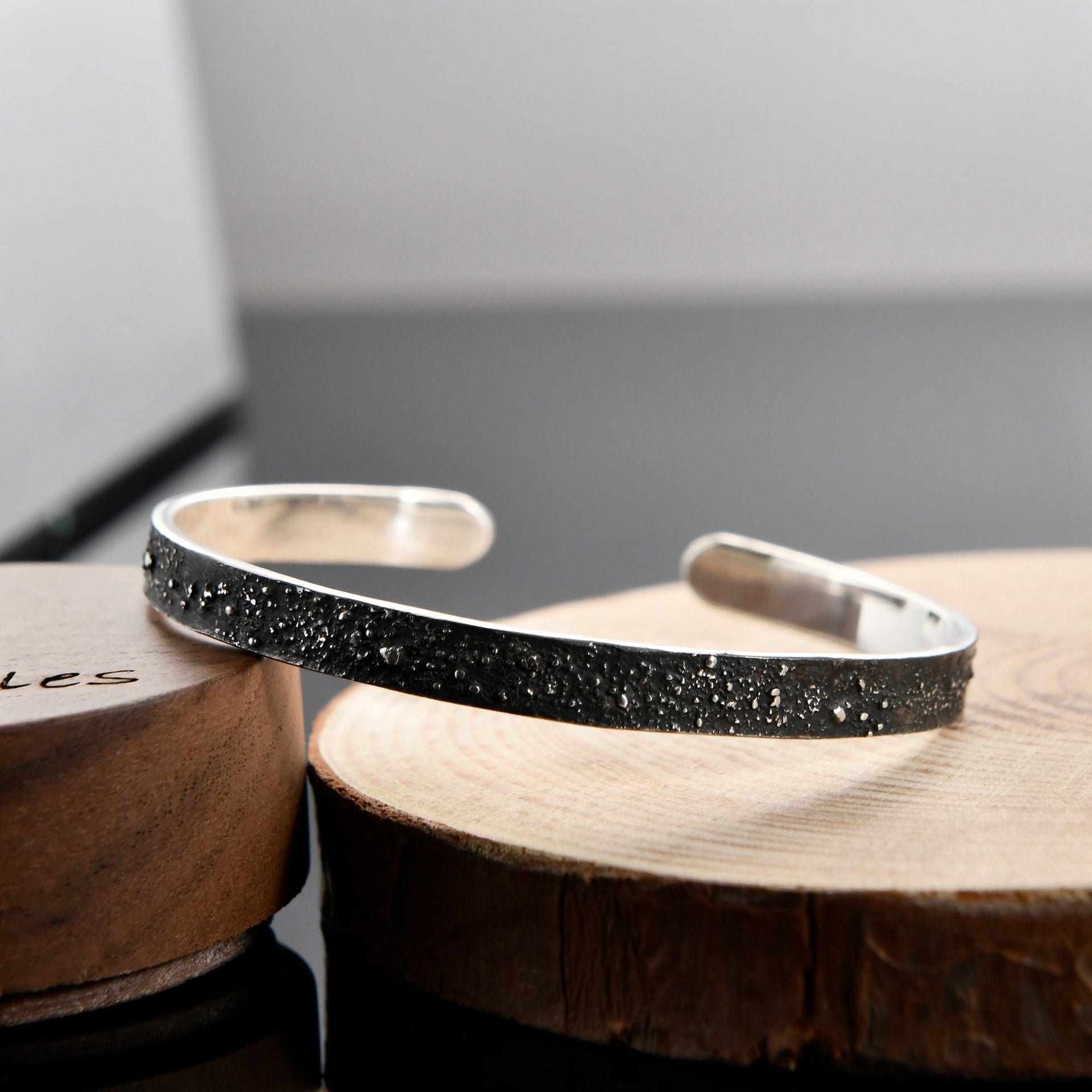 Gunmetal grey narrow cuff bracelet with engraved night sky design