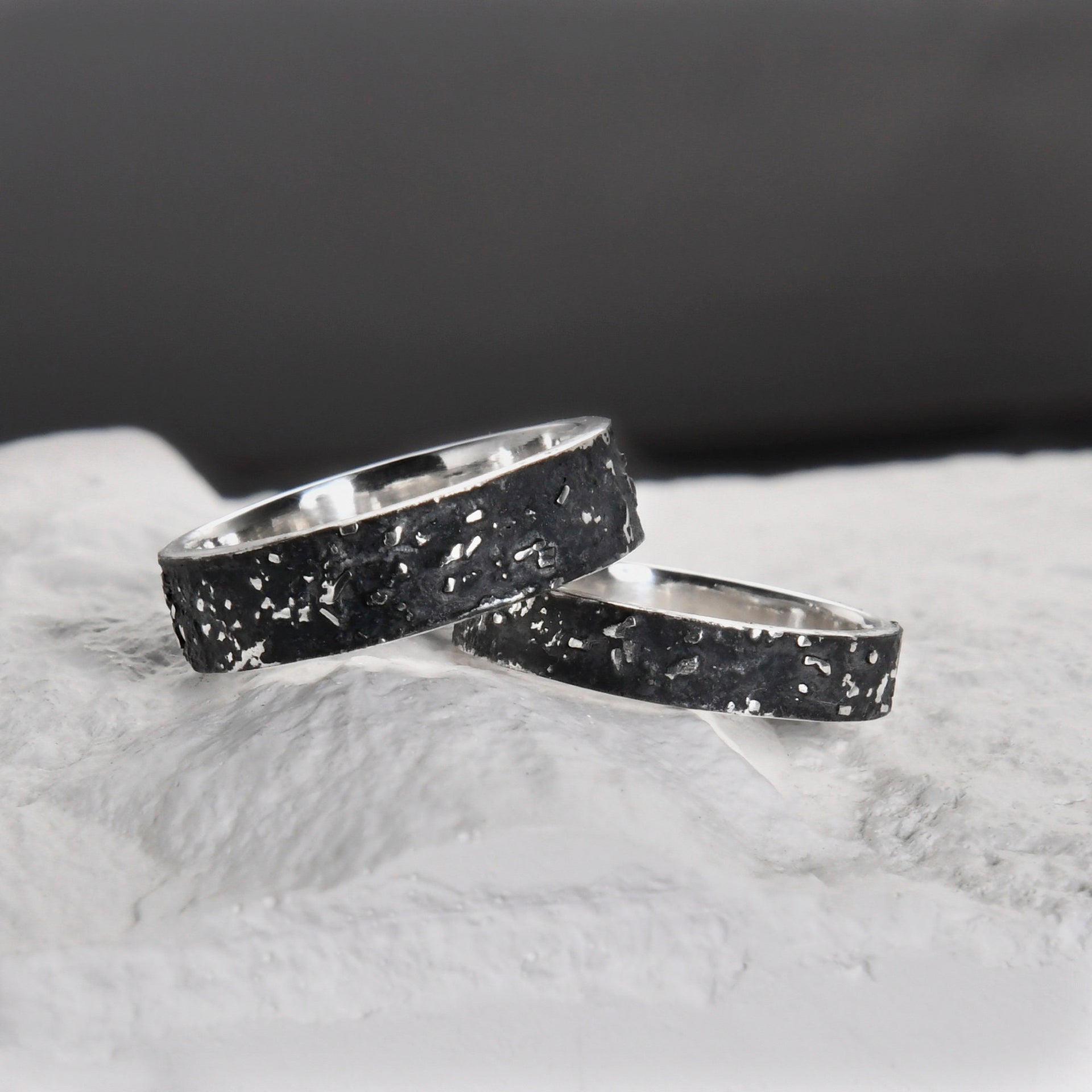 Close-up of the 4mm and 6mm galaxy texture rings with rugged oxidized sterling silver surfaces.