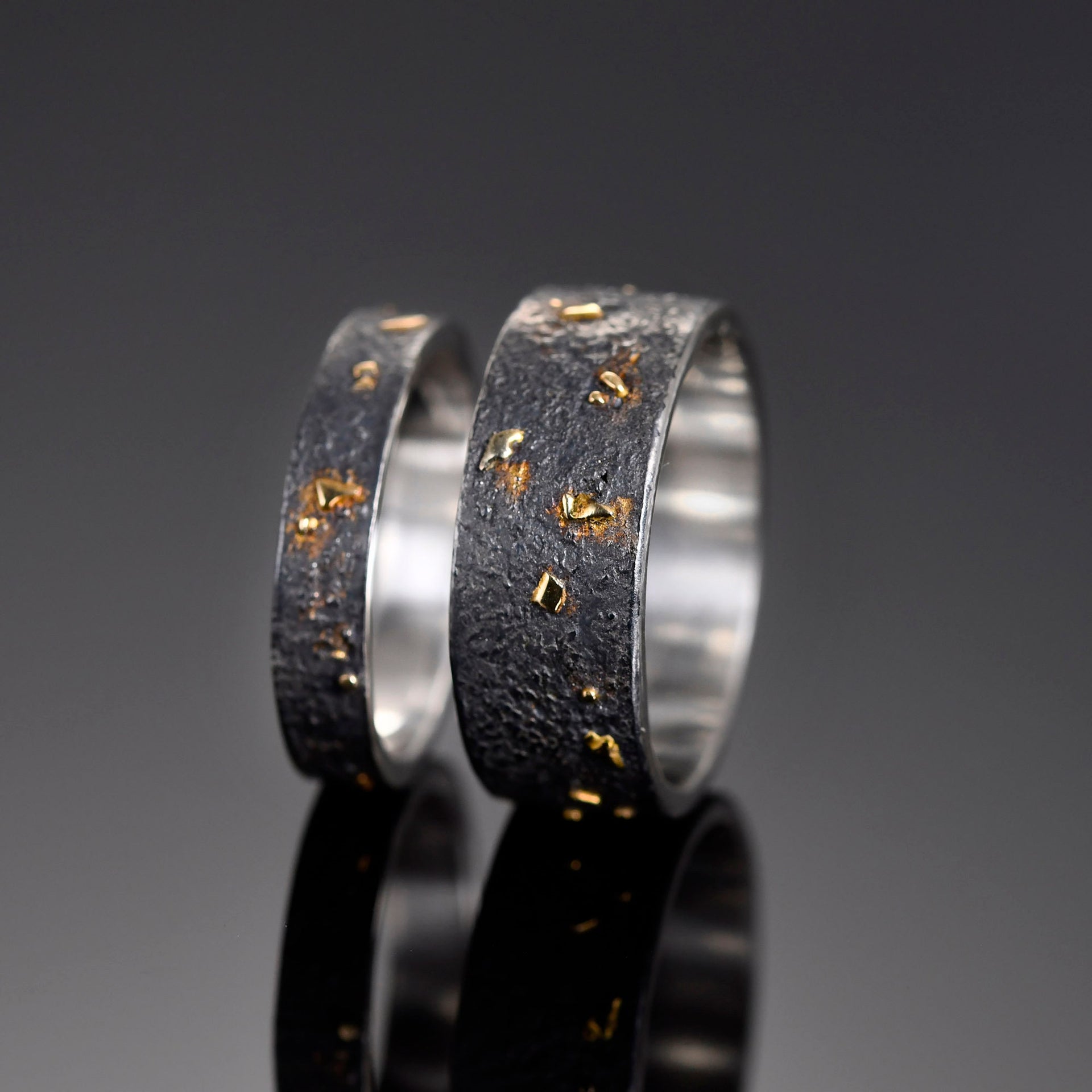 Solid 18K gold accents fused into a black silver handmade band