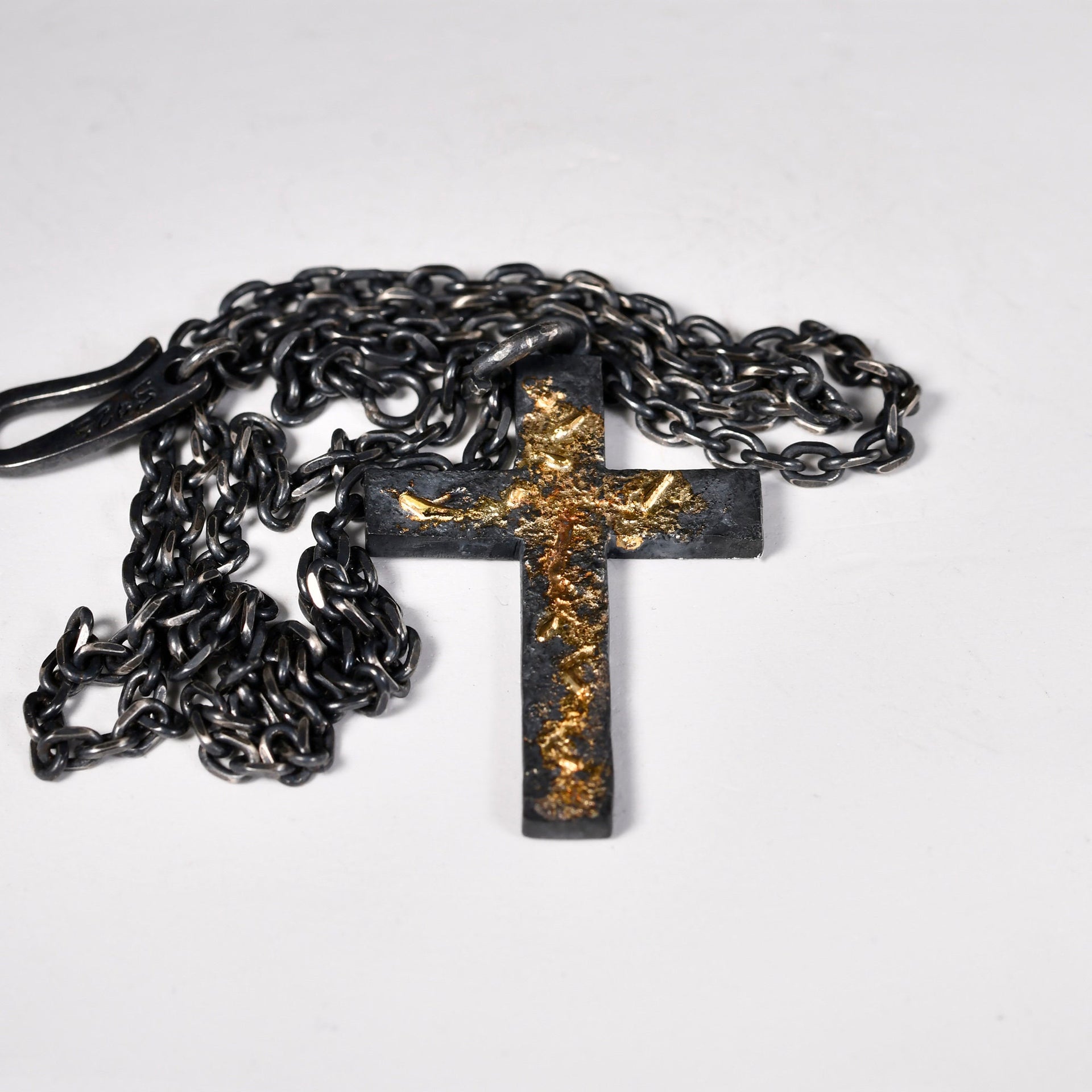 YophieMade oxidized silver cross necklace with warm gold leaf detail