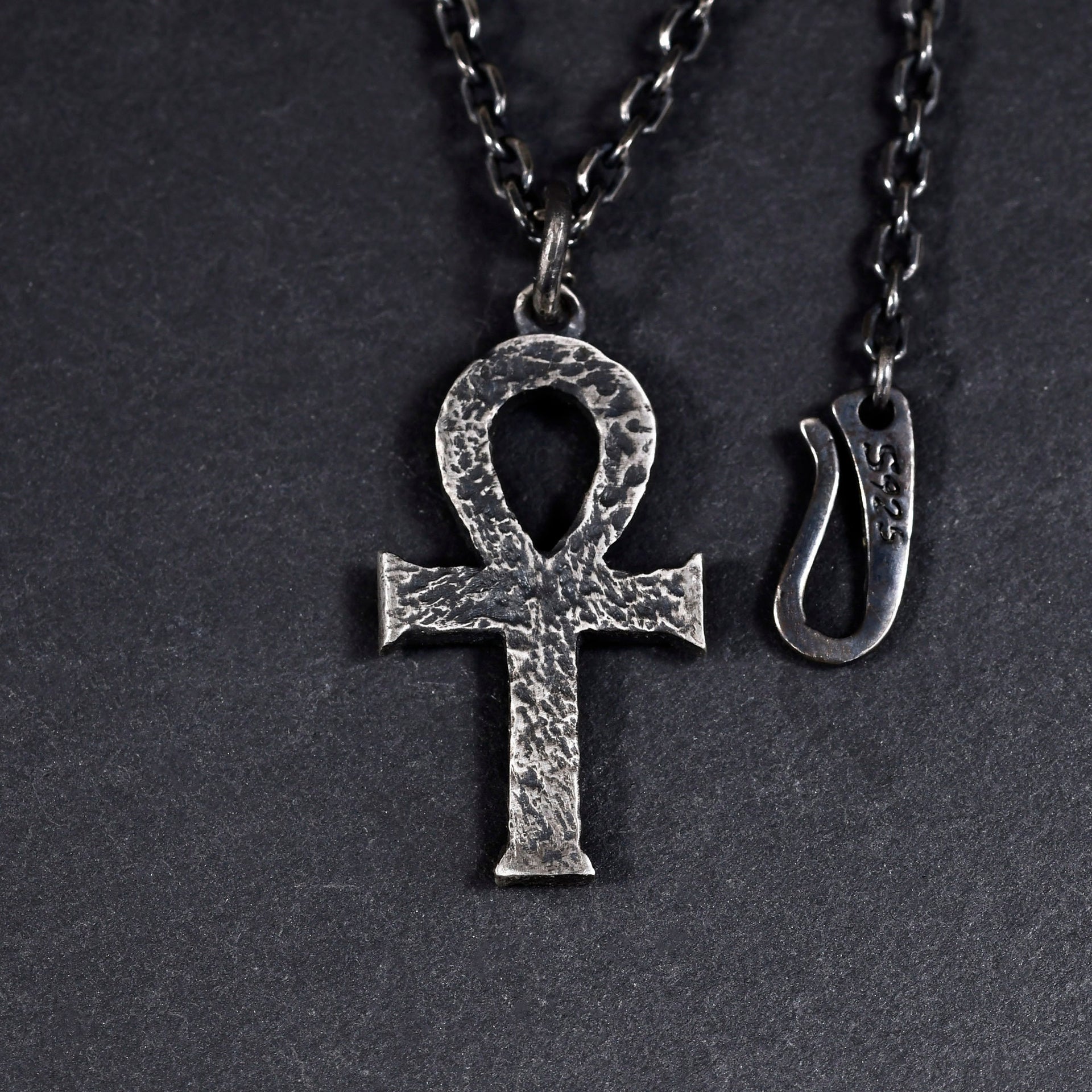 Sterling silver ankh cross charm shown with textured handmade detail