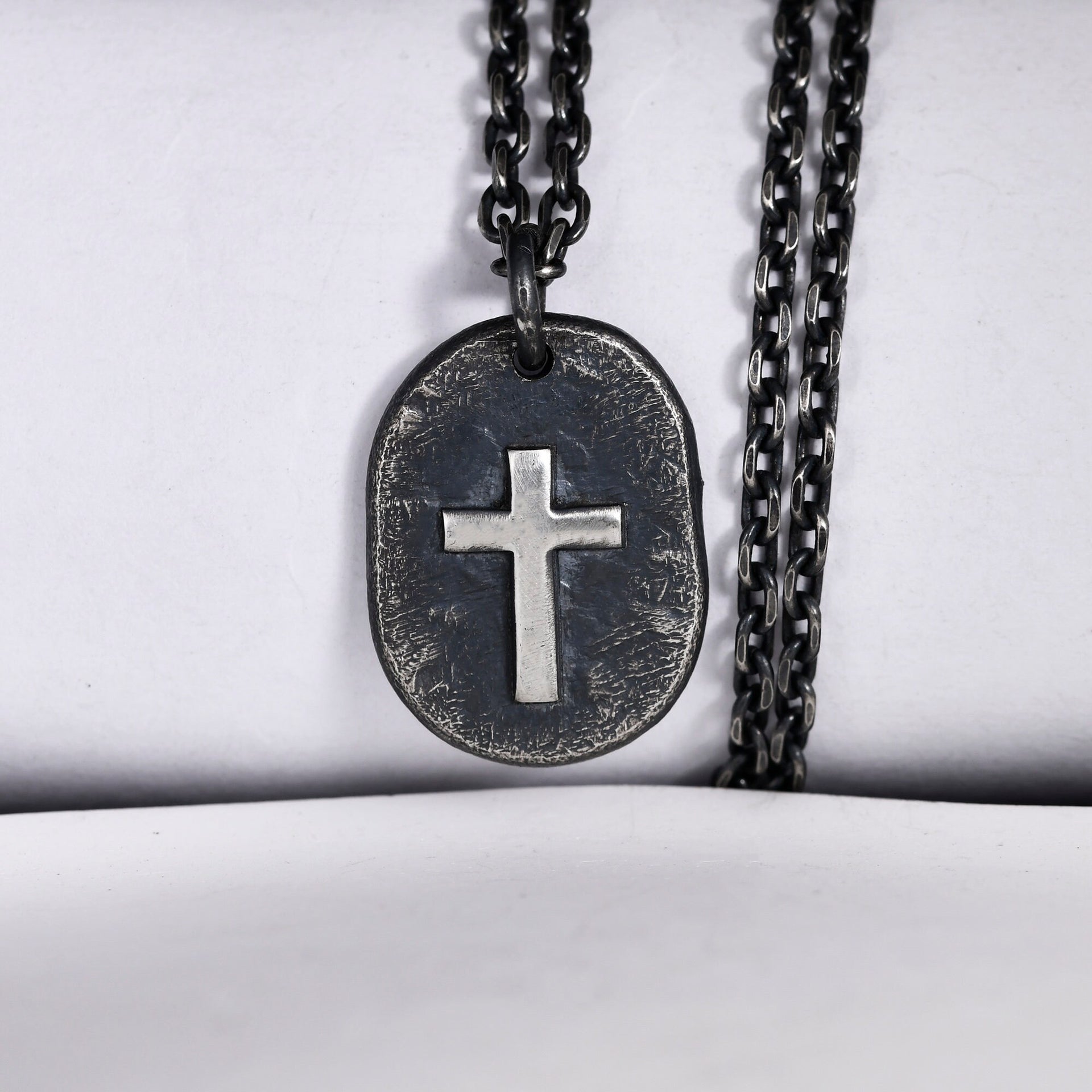 Black silver cross necklace pendant worn as meaningful faith jewelry