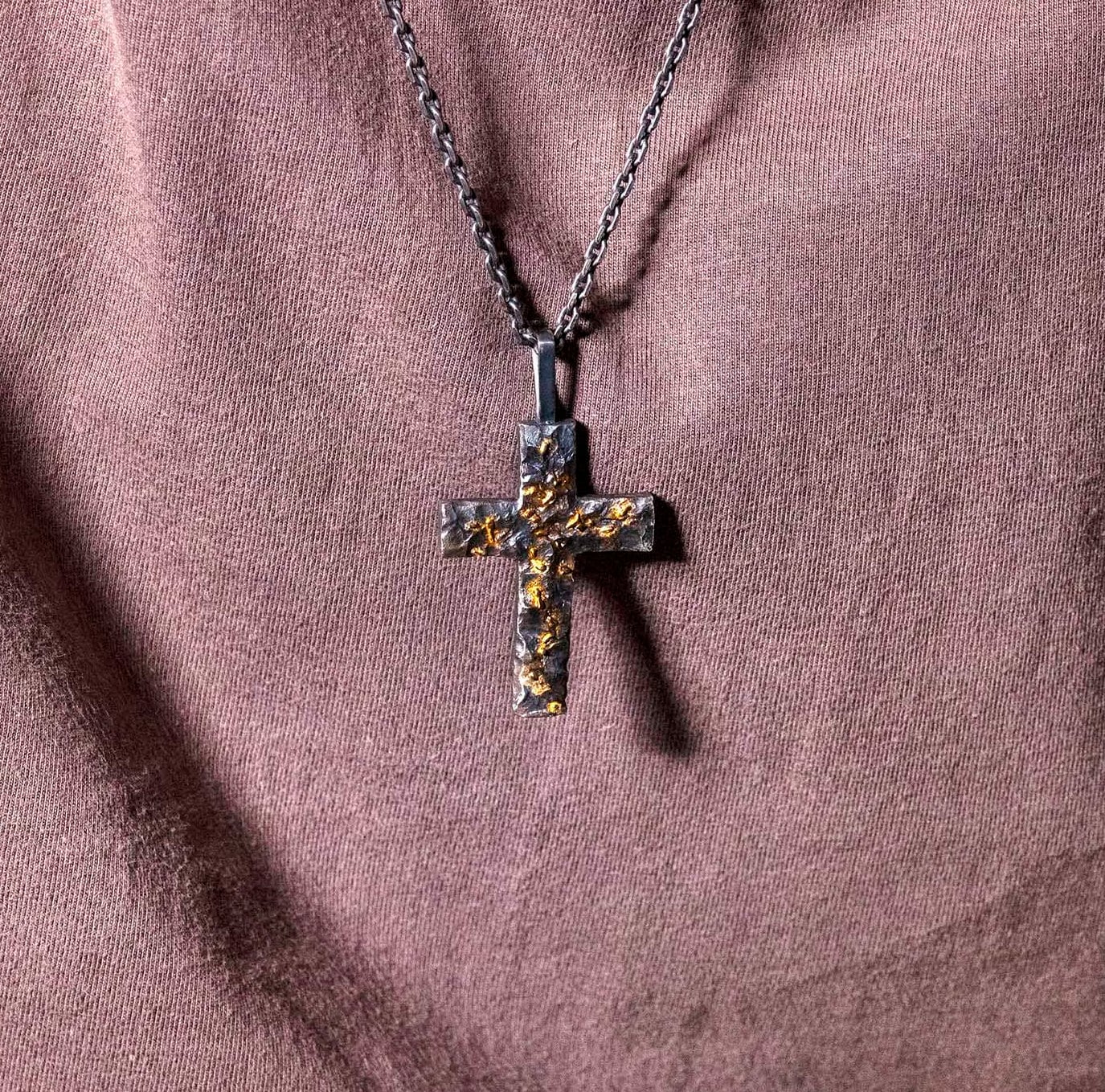 YophieMade black silver cross pendant showing textured handmade surface