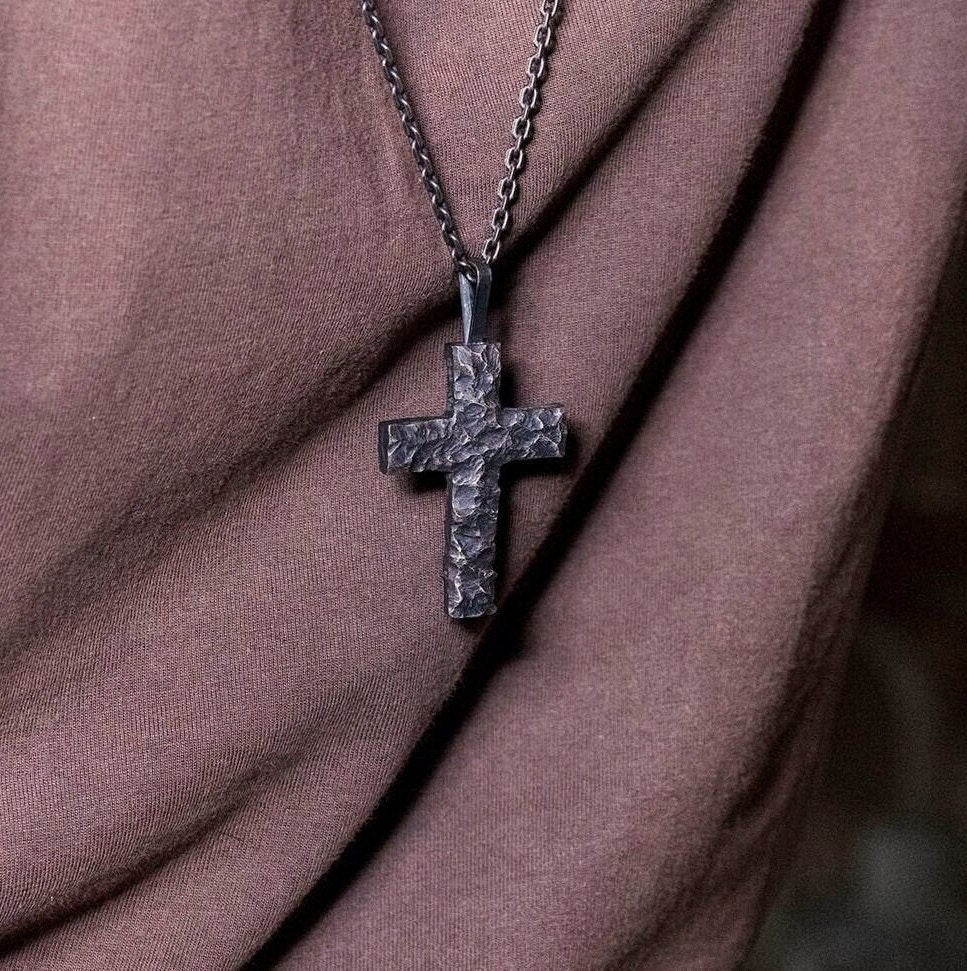 Black silver cross pendant worn as bold everyday Christian jewelry