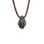 Back of the beanie skull pendant showing the ribbed knit texture of the hat and the leather cord loop, oxidized nickel silver