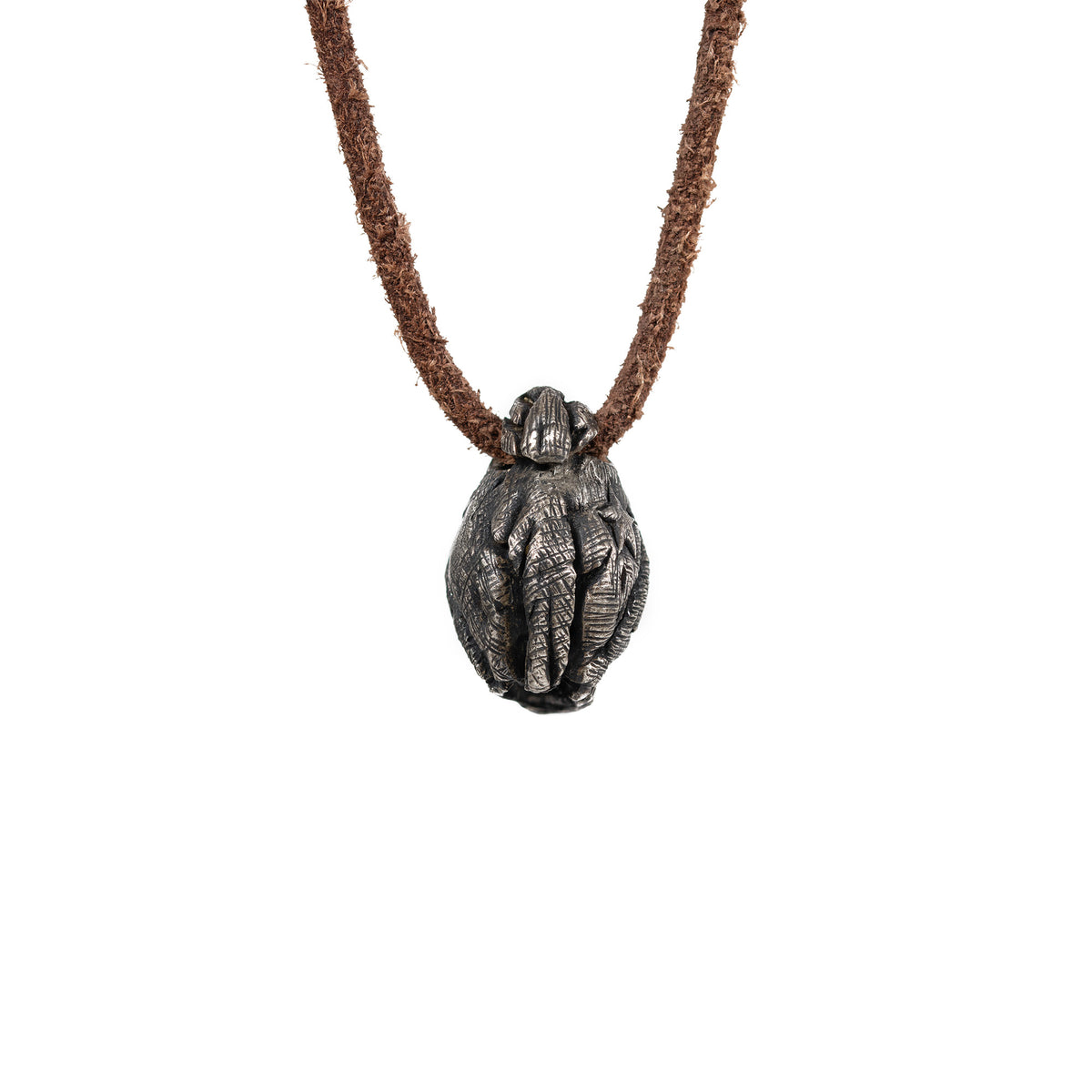 Back of the beanie skull pendant showing the ribbed knit texture of the hat and the leather cord loop, oxidized nickel silver