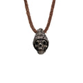 Men's beanie skull necklace in oxidized nickel silver, front view of the hand carved skull pendant in a ribbed knit beanie on a dark brown leather cord, white background