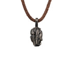 Back and top of the exposed brain skull pendant showing the carved brain folds and the flat bail, oxidized nickel silver