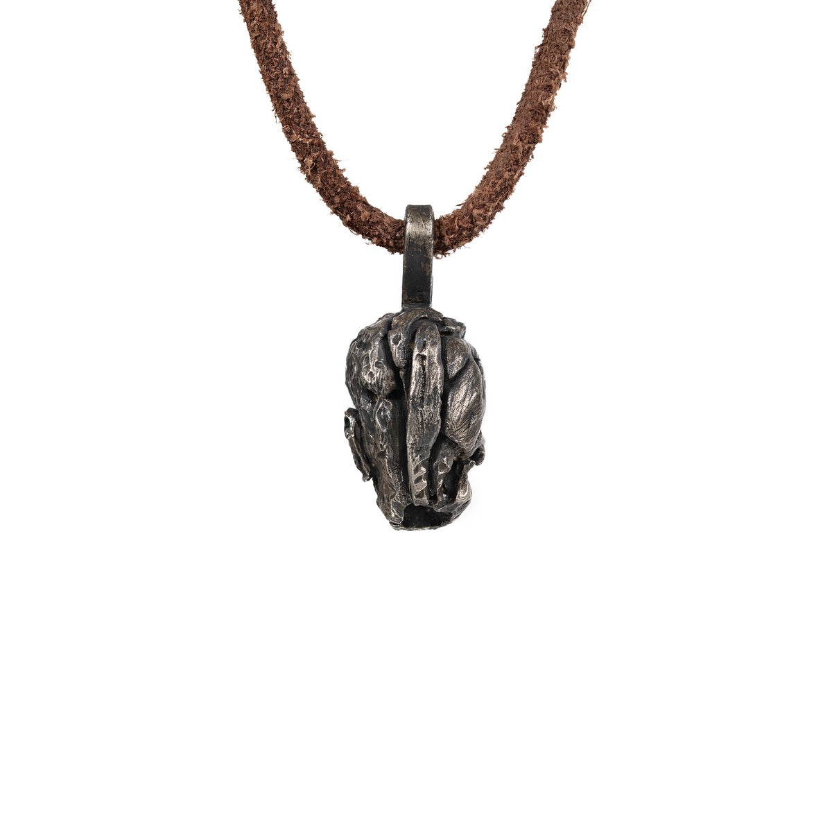 Back and top of the exposed brain skull pendant showing the carved brain folds and the flat bail, oxidized nickel silver