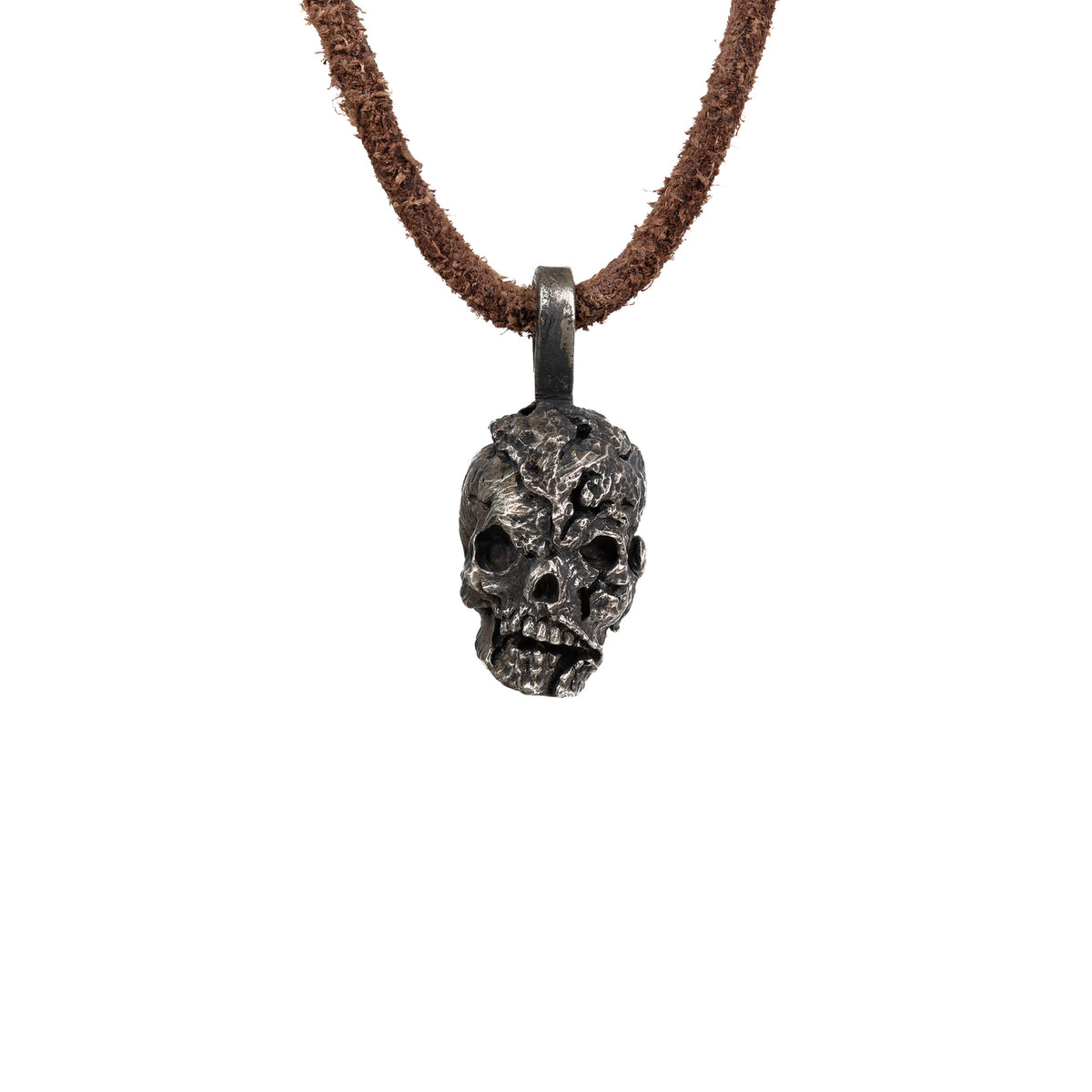 Men's exposed brain skull necklace in oxidized nickel silver, front view of the hand carved skull pendant with an open cranium on a dark brown leather cord, white background