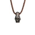 Men's top hat skull necklace in oxidized nickel silver, front view of the hand carved skull pendant on a dark brown leather cord, white background