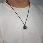 Model wearing the double-face skull pendant on a plain t-shirt for everyday styling.
